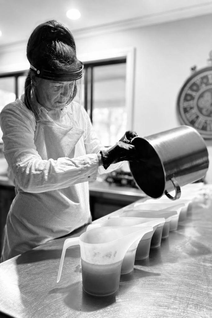 Mel from Love Bobbie pouring handmade soap into a mould